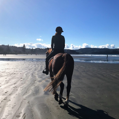 Nicqui Redman riding horse on Orewa Beach Auckland NZ